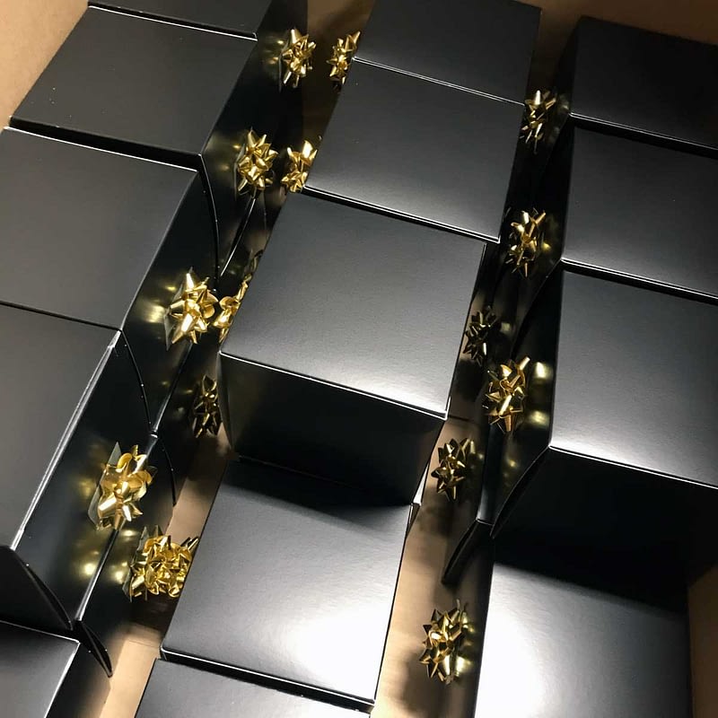 Kindred Group Christmas presents packed in golden boxes