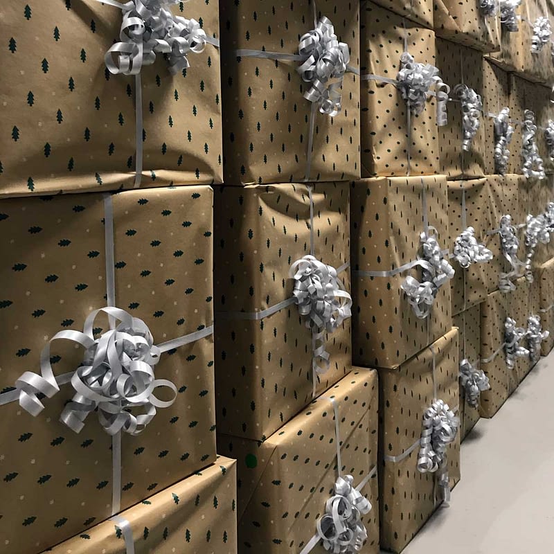 Kindred Group Christmas presents packed in golden boxes